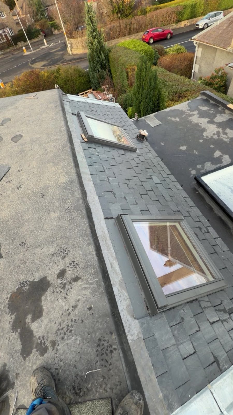Two Velux windows in a slate roof beside a flat roof, Edinburgh