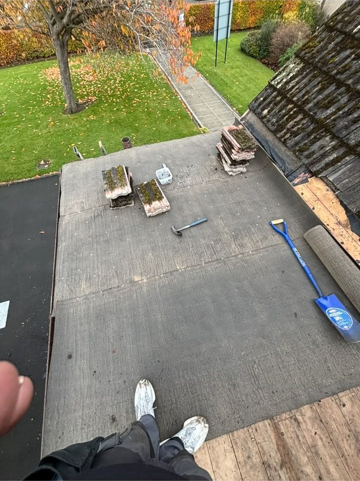 Flat roof being felted beside a pitched roof, Edinburgh