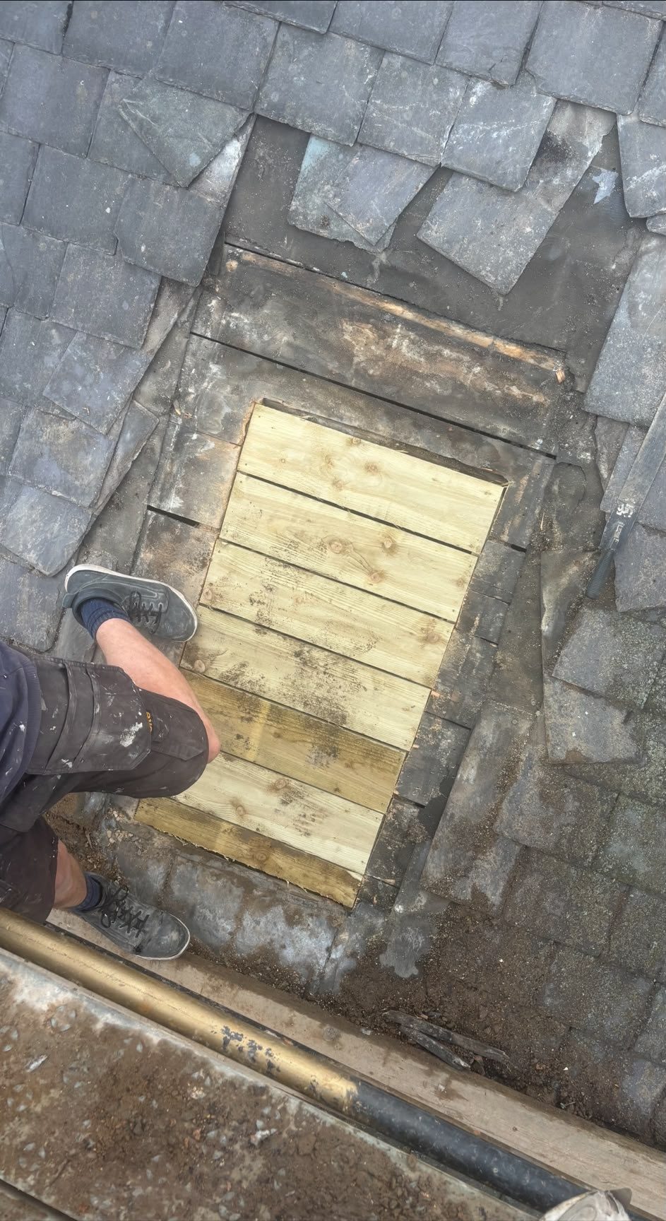 Timber boarding patched into a slate roof during a repair, Edinburgh