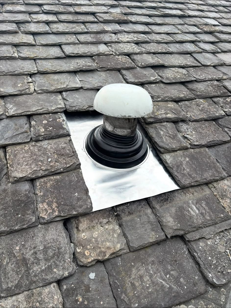 Lead flashing dressed around a roof vent pipe on a slate roof, Edinburgh