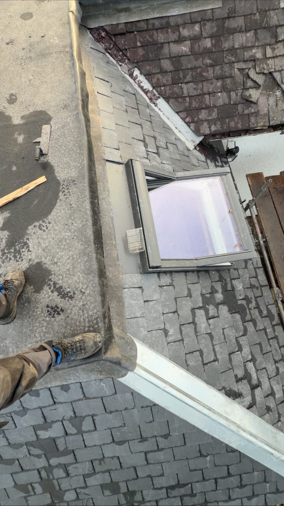 Velux window fitted in a slate roof beside a flat roof, Edinburgh