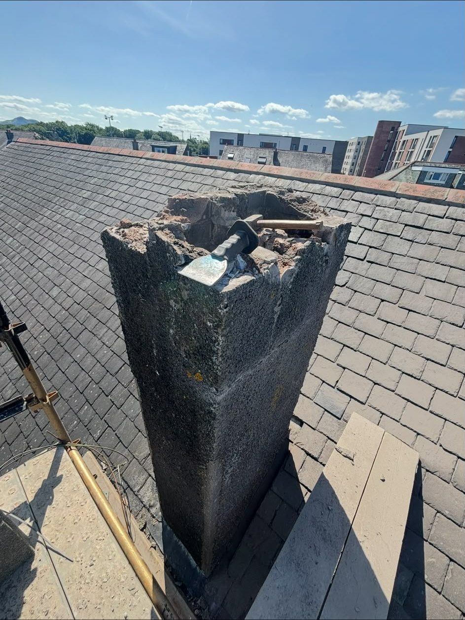 Damaged chimney stack on a slate roof before repair, Edinburgh