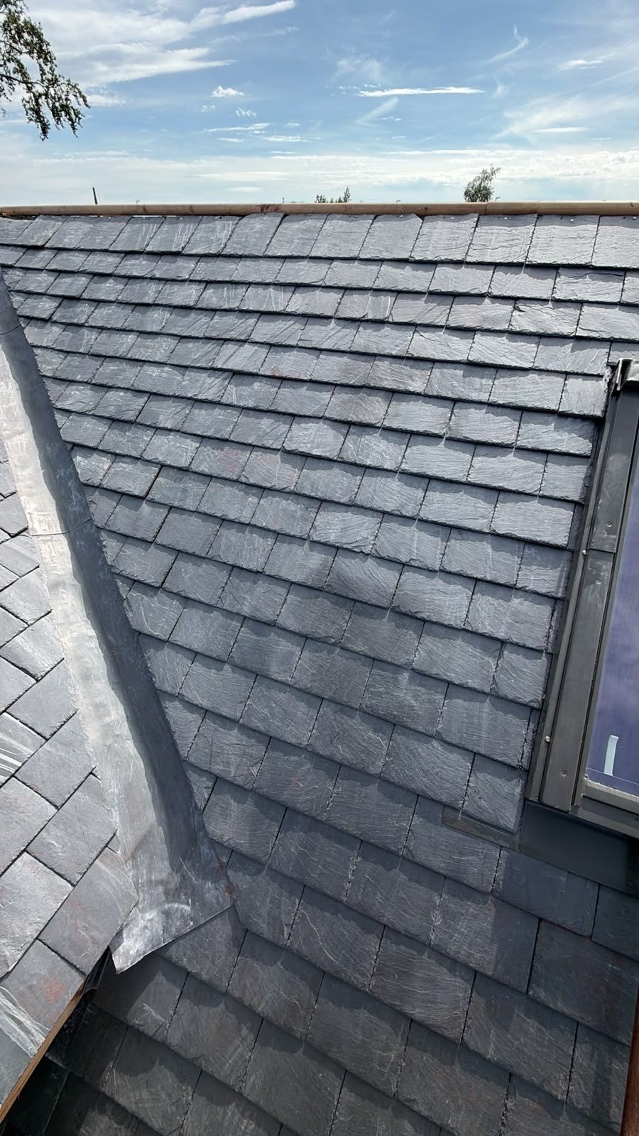 Slate roof with new lead flashing beside a window, Edinburgh