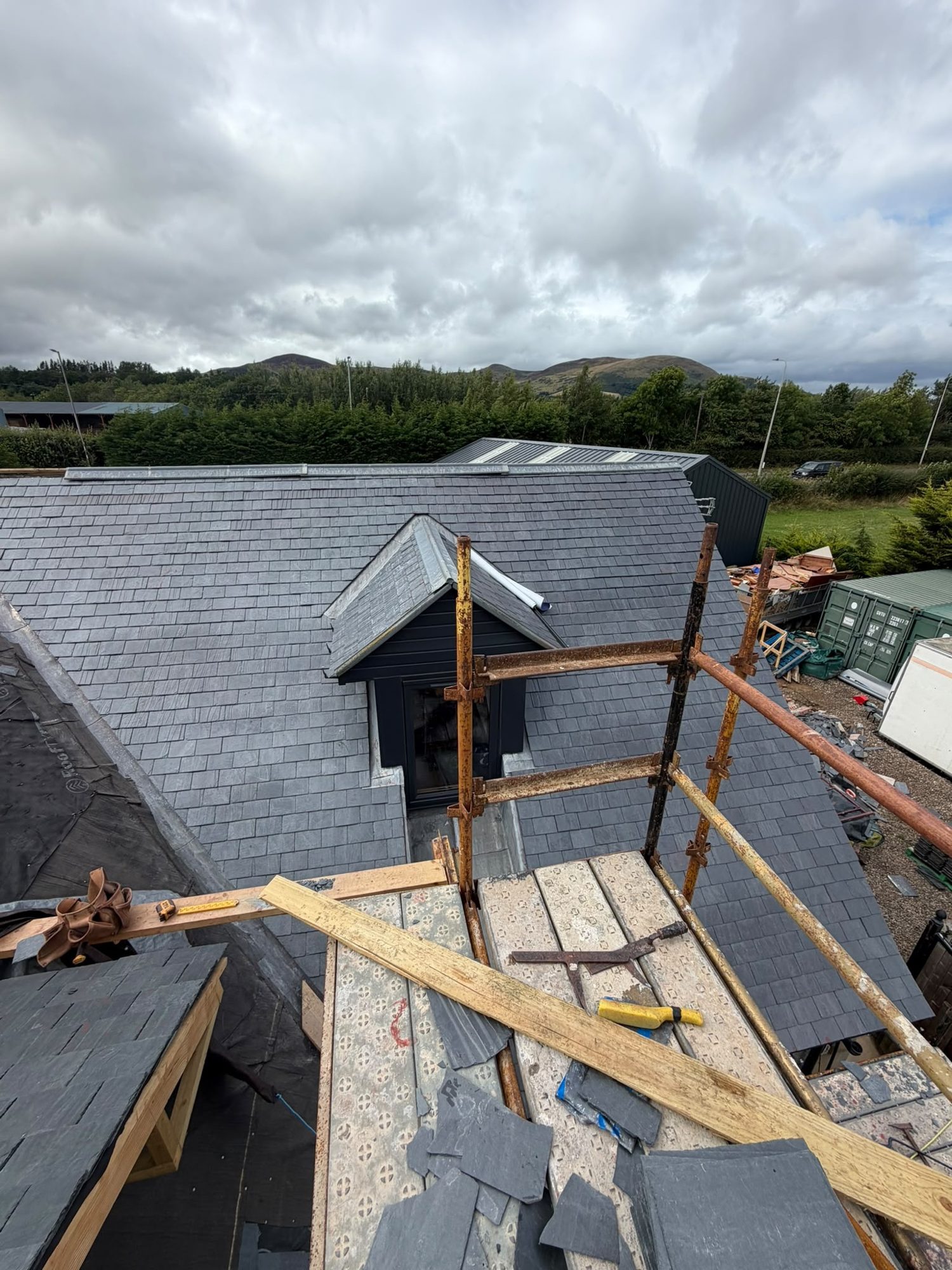 Slate roof with a dormer and scaffold during roofing work near Edinburgh