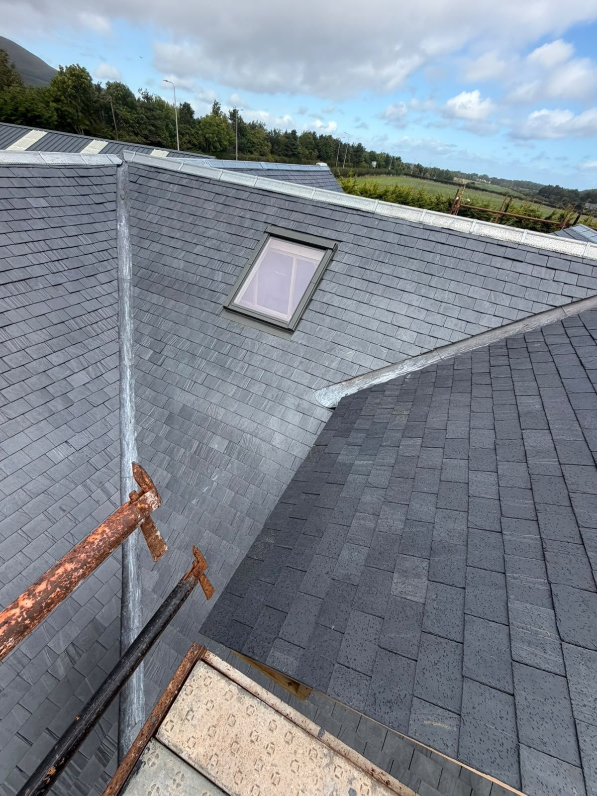 Completed full re-roof in natural slate with a Velux window and lead valley, Edinburgh