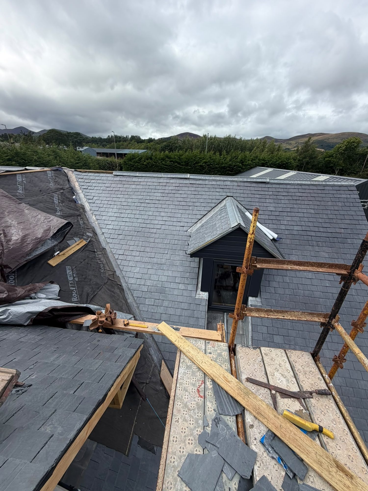 Slate roof opened up with membrane and new timber during emergency roof repairs, Edinburgh