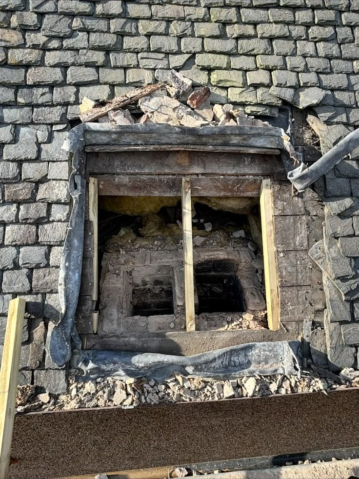Opening in a slate roof before chimney removal repair, Edinburgh