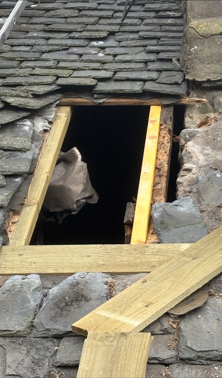 Storm-damaged slate roof opened up with new timber framing during an emergency repair in Edinburgh