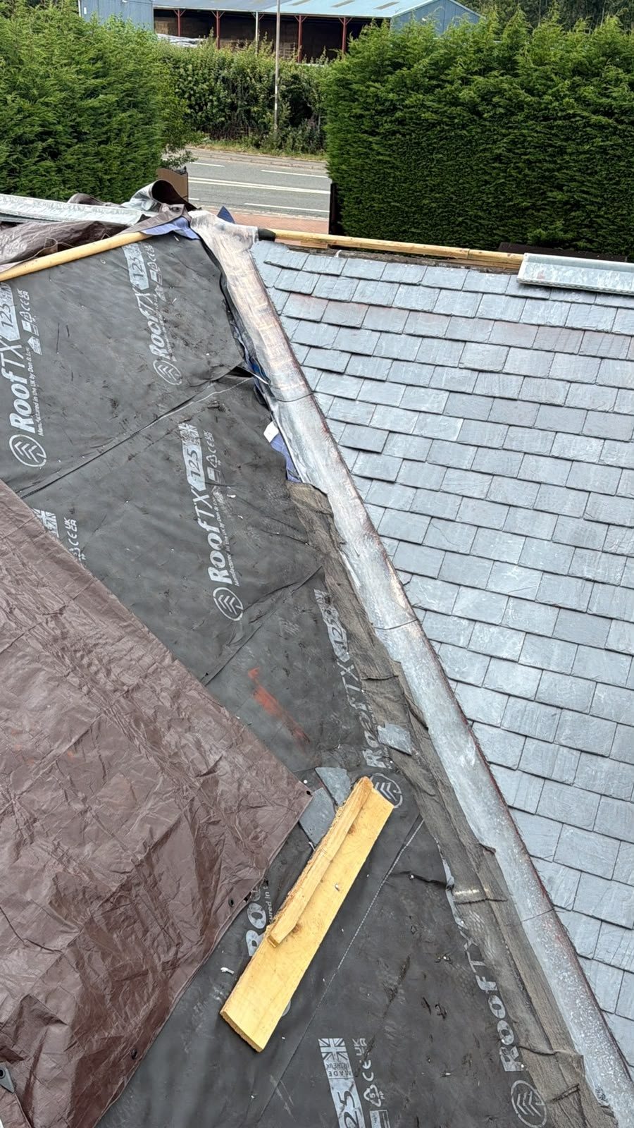 Old roof covering removed and new slates fitted during a re-roof, Edinburgh